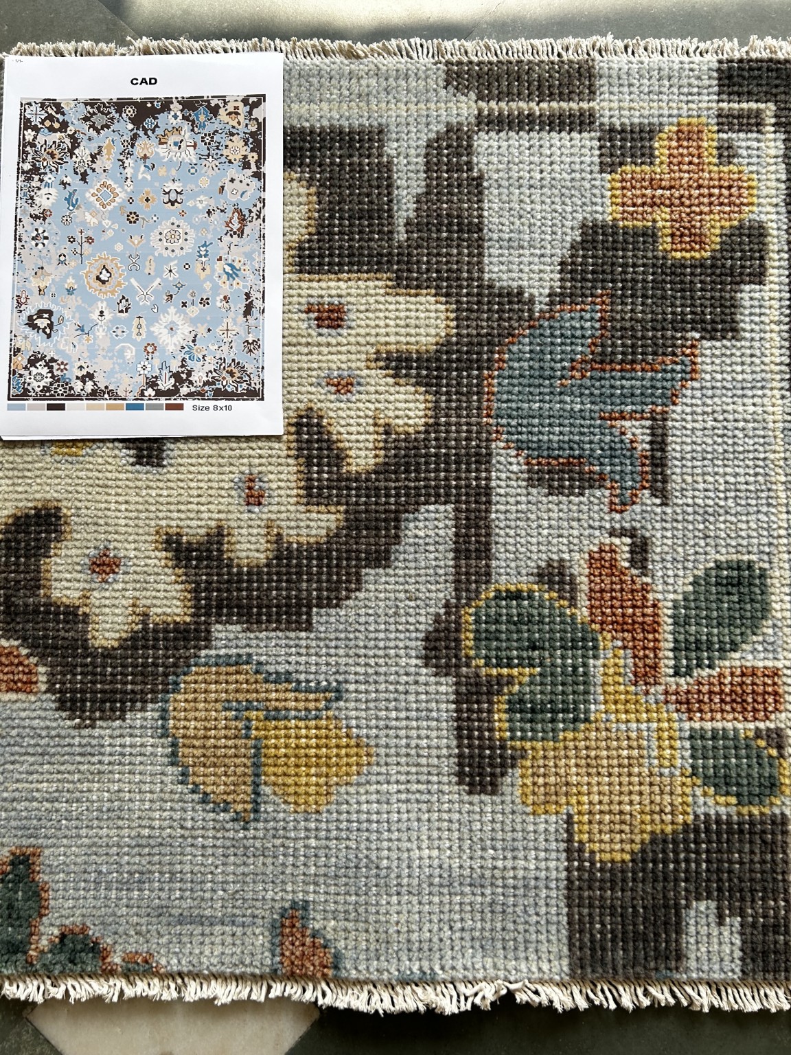 Soft blue Oushak rug sample with hand-knotted floral motifs